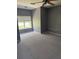Neutral bedroom featuring a large window and carpeted floors at 1903 Turnbull Lakes Dr # 1903, New Smyrna Beach, FL 32168