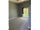 Spacious bedroom featuring carpet floors and a sliding glass door leading to the balcony at 1903 Turnbull Lakes Dr # 1903, New Smyrna Beach, FL 32168