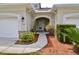 Inviting front entrance with decorative shrubs and mulched flower beds around the walkway at 1903 Turnbull Lakes Dr # 1903, New Smyrna Beach, FL 32168