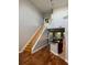 Bright entryway featuring a staircase and hardwood floors leading to the kitchen at 1903 Turnbull Lakes Dr # 1903, New Smyrna Beach, FL 32168