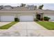 Charming townhouse featuring an attached two-car garage, meticulous landscaping, and a welcoming front entrance at 1903 Turnbull Lakes Dr # 1903, New Smyrna Beach, FL 32168