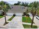 An impressive full view of the front of the townhomes showcasing the spacious driveways and lovely landscaping at 1903 Turnbull Lakes Dr # 1903, New Smyrna Beach, FL 32168