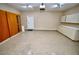 Well-lit garage featuring lots of cabinet storage, speckled epoxy flooring, and a clean, organized layout at 1903 Turnbull Lakes Dr # 1903, New Smyrna Beach, FL 32168
