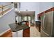 Open concept kitchen with granite countertops and stainless steel appliances overlooking the living area at 1903 Turnbull Lakes Dr # 1903, New Smyrna Beach, FL 32168