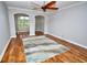 Inviting living room featuring hardwood floors, stylish ceiling fan, and decorative archways at 1903 Turnbull Lakes Dr # 1903, New Smyrna Beach, FL 32168