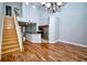 Open-concept living and dining area features hardwood floors, a high ceiling, and a staircase to the second floor at 1903 Turnbull Lakes Dr # 1903, New Smyrna Beach, FL 32168