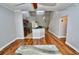 Bright, open-concept living area with hardwood floors and views into the modern kitchen at 1903 Turnbull Lakes Dr # 1903, New Smyrna Beach, FL 32168