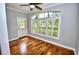 Bright sunroom with hardwood floors, plantation shutters, and natural light at 1903 Turnbull Lakes Dr # 1903, New Smyrna Beach, FL 32168