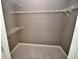 A walk-in closet features ample shelving space with gray carpet and light-colored walls at 1903 Turnbull Lakes Dr # 1903, New Smyrna Beach, FL 32168