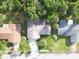 A bird's-eye view captures this beautiful home surrounded by lush greenery and mature trees, offering privacy and natural beauty at 208 Wellington Dr, Daytona Beach, FL 32119