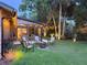Backyard features a firepit and patio area with seating at 208 Wellington Dr, Daytona Beach, FL 32119