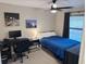 Comfortable bedroom with a desk, window, ceiling fan, and neutral walls at 208 Wellington Dr, Daytona Beach, FL 32119