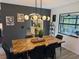 Elegant dining room with a unique herringbone table and modern lighting, ideal for entertaining at 208 Wellington Dr, Daytona Beach, FL 32119