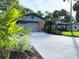 Charming home featuring a well-manicured lawn, lush landscaping, and a two-car garage at 208 Wellington Dr, Daytona Beach, FL 32119