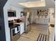 Well-equipped kitchen with stainless steel appliances, white cabinets, and a view into the dining area at 208 Wellington Dr, Daytona Beach, FL 32119