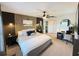 Stylish main bedroom featuring a ceiling fan, accent wall, and home office setup at 208 Wellington Dr, Daytona Beach, FL 32119