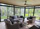 Sunroom with ample seating, ceiling fan, and natural light at 208 Wellington Dr, Daytona Beach, FL 32119