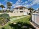 Lovely backyard with lush landscaping, a walking path, and a view of the well-maintained community at 2100 N Peninsula Ave # 2160, New Smyrna Beach, FL 32169
