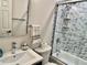 This bathroom has a vessel sink and shower/tub combo with decorative tiling at 2100 N Peninsula Ave # 2160, New Smyrna Beach, FL 32169