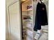 Organized closet with shelves, hanging space, and sliding doors for easy access at 2100 N Peninsula Ave # 2160, New Smyrna Beach, FL 32169
