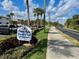 Entrance sign to the 'Ocean Inlet Yacht Club Condominium' amidst lush landscaping at 2100 N Peninsula Ave # 2160, New Smyrna Beach, FL 32169