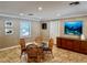 Bright dining area featuring a glass-top table with seating for four and a stylish marine-themed painting at 2100 N Peninsula Ave # 2160, New Smyrna Beach, FL 32169