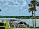Scenic waterfront view with a private dock, boat slip, and beautiful landscaping at 2100 N Peninsula Ave # 2160, New Smyrna Beach, FL 32169