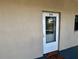 Inviting entrance with a white trimmed door, welcome mat, and elegant glass detail for a touch of charm at 2100 N Peninsula Ave # 2160, New Smyrna Beach, FL 32169