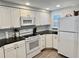Efficient kitchen with white appliances, sleek countertops, and ample cabinet space, ready for your culinary creations at 2100 N Peninsula Ave # 2160, New Smyrna Beach, FL 32169