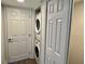 Laundry room with stackable washer and dryer unit and a door to a closet at 2100 N Peninsula Ave # 2160, New Smyrna Beach, FL 32169