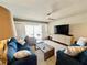 Comfortable living room features stylish sofas, a modern ceiling fan, and sliding doors to the lanai at 2100 N Peninsula Ave # 2160, New Smyrna Beach, FL 32169