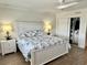 Bright main bedroom featuring a closet, ceiling fan, and two nightstands with lamps at 2100 N Peninsula Ave # 2160, New Smyrna Beach, FL 32169