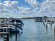 Picturesque marina view with boats docked on tranquil waters under a partly cloudy blue sky at 2100 N Peninsula Ave # 2160, New Smyrna Beach, FL 32169