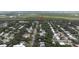 An aerial view showcases property and surrounding residential area near a lush marshland at 2107 Saxon Dr, New Smyrna Beach, FL 32169