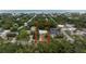 An aerial view highlights the property's location among lush trees and close proximity to the ocean at 2107 Saxon Dr, New Smyrna Beach, FL 32169