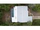 An aerial view highlights the home with screen enclosed pool and adjacent surroundings with mature landscaping at 2107 Saxon Dr, New Smyrna Beach, FL 32169
