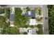 An aerial view displays the home's layout, neighboring properties, swimming pool, and surrounding green landscape at 2107 Saxon Dr, New Smyrna Beach, FL 32169