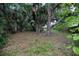 Lush backyard with mature trees offers a serene and private outdoor space at 2107 Saxon Dr, New Smyrna Beach, FL 32169