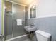 Full bathroom with tiled shower, toilet, and sink with mirror at 2107 Saxon Dr, New Smyrna Beach, FL 32169