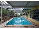 Enjoy this sunny screened in pool with clear blue water, perfect for relaxation and enjoyment at 2107 Saxon Dr, New Smyrna Beach, FL 32169