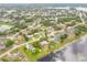 Aerial shot shows neighborhood, lake, and landscaped yards at 2435 Alton Rd, Deltona, FL 32738