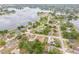 Wide angle aerial showcasing neighborhood homes near lake at 2435 Alton Rd, Deltona, FL 32738