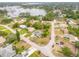 Serene aerial view of a neighborhood near a lake, showcasing lush landscapes and peaceful residential streets at 2435 Alton Rd, Deltona, FL 32738