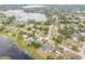 Property aerial showcasing neighborhood near lake and well-maintained yards at 2435 Alton Rd, Deltona, FL 32738
