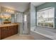 Bright bathroom features a shower, soaking tub, and vanity with a large mirror at 2435 Alton Rd, Deltona, FL 32738