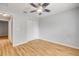Bedroom features hardwood floors, a ceiling fan, a door to the hallway, and a closet with double doors at 2435 Alton Rd, Deltona, FL 32738