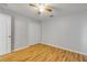 Bedroom features hardwood floors, a ceiling fan, a door to the hallway, and a closet with double doors at 2435 Alton Rd, Deltona, FL 32738