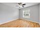 Cozy bedroom with hardwood floors, a ceiling fan, and a window with blinds allows for lots of natural light at 2435 Alton Rd, Deltona, FL 32738