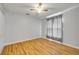 Clean bedroom with hardwood floors, ceiling fan, and a window with curtains allows for lots of natural light at 2435 Alton Rd, Deltona, FL 32738