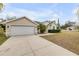 Well-maintained home featuring an attached two-car garage and freshly cut lawn at 2435 Alton Rd, Deltona, FL 32738